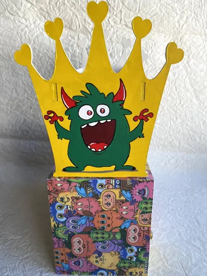 The other side of the holder features a happy green monster, making it fun and colorful from all angles.