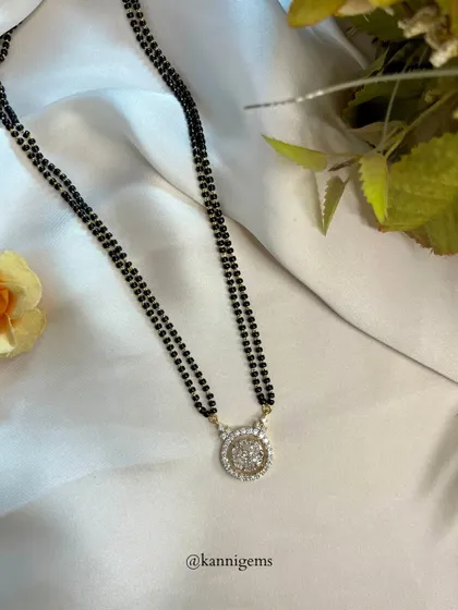 This mangalsutra is a cherished symbol of love and commitment. The stunning round diamond pendant creates a design that is equal parts timeless and modern, perfect for elevating your everyday look.