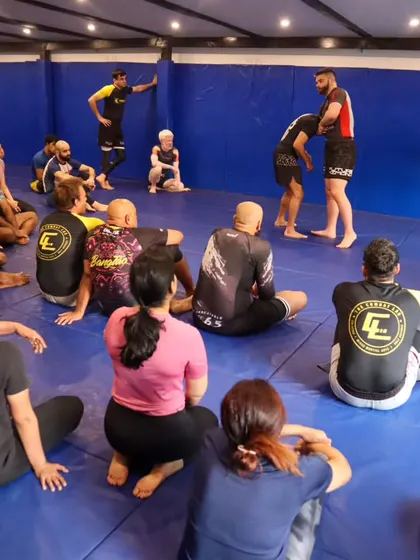 A wide shot of the group learning from Coach Mike. Our seminars bring together grapplers from all over, creating a great environment for learning and sharing knowledge.