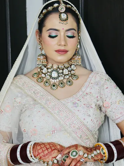A full-face view with eyes closed, showing the perfect symmetry of the makeup.