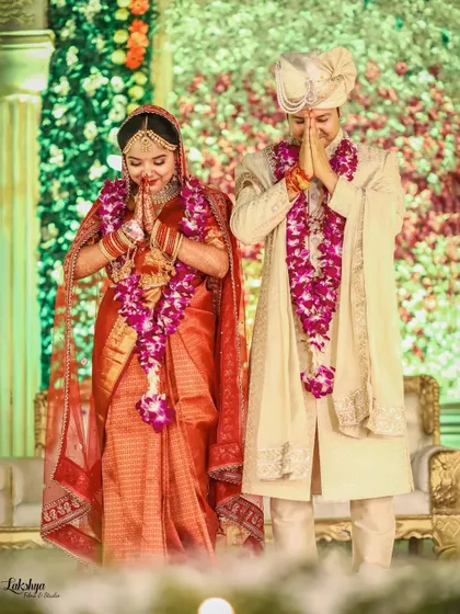 The couple greeting their guests with a respectful 'namaste'. This photo captures their grace and gratitude during the wedding reception.