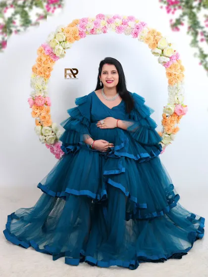 A beautiful solo portrait in our floral hoop. The mom-to-be is surrounded by soft-colored flowers, perfectly complementing her elegant blue ruffled gown.