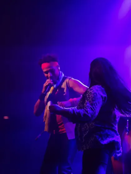 David Walters invites an audience member to dance on stage with him. This moment of spontaneous interaction highlights the fun and inclusive atmosphere of our concerts.