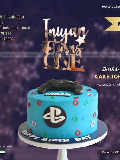 For little Iniyan's first birthday, we went with a fun PlayStation theme. This custom cake features the iconic controller and symbols, paired with a personalized rose gold topper to celebrate the little gamer.