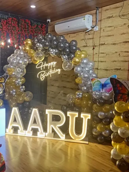 This butterfly theme for Aaru's first birthday uses a stylish black, silver, and gold color scheme. It shows how a popular theme can be customized to look unique and modern.