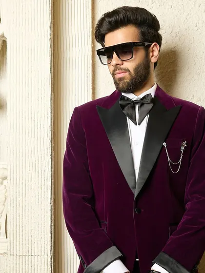 Another view of the wine velvet tuxedo, showcasing its impeccable fit and luxurious sheen under ambient light. The perfect choice for a sophisticated evening.