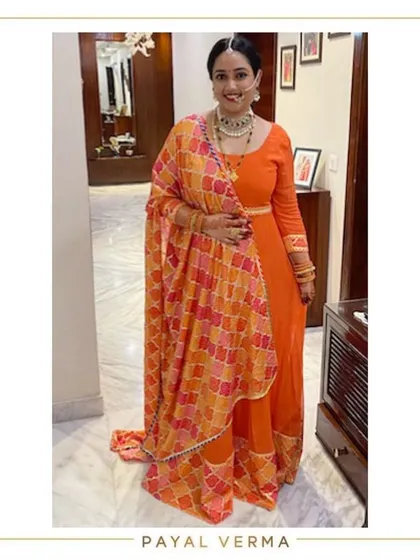 Celebrating a first Karvachauth in shades of orange. I designed this orange anarkali and paired it with a multi-hued shaded dupatta finished with gota for a festive, memorable look.