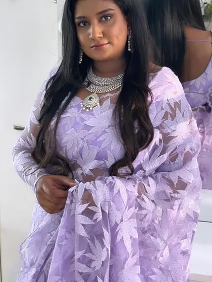 A close-up showing the beautiful texture of the lavender saree and how it pairs with diamond jewelry.