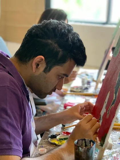 A guest at our koi fish painting session, completely absorbed in the process. Our studio is a place to find your creative flow.