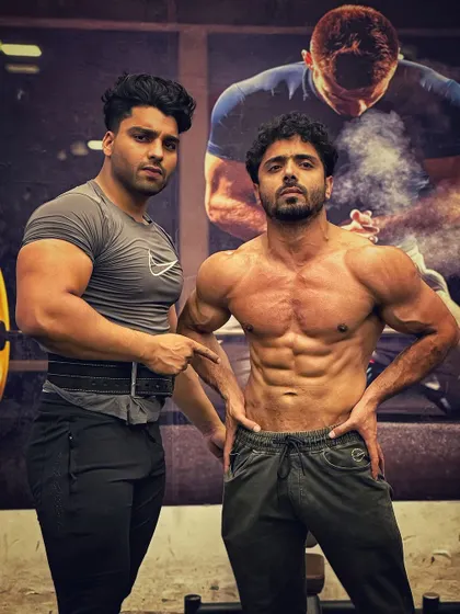 Posing with a client. His goal is to compete in men's physique, and we are building the foundation for a winning look.