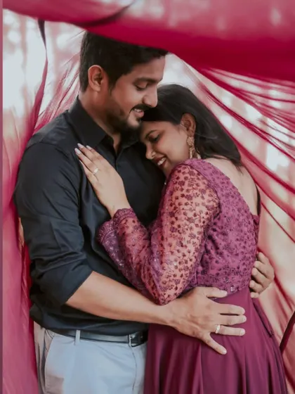 Wrapped in love and a beautiful flowing fabric. This intimate shot showcases the connection between the couple, with their outfits creating a cozy and romantic feel.