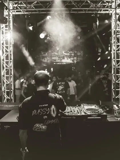 A black and white shot from behind, showing the details on my shirt and my focus on the Pioneer mixer.