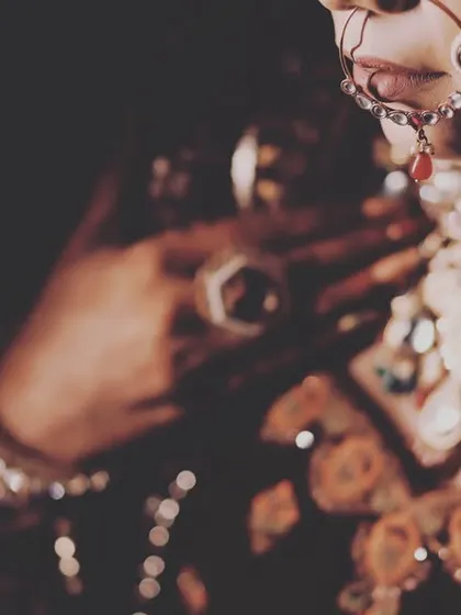 A creative close-up focusing on the bride's magnificent jewelry and the details of her makeup. This is a perfect shot for any wedding album.