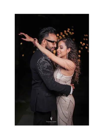 The couple sharing a dance at their reception, with beautiful bokeh lights in the background creating a magical atmosphere.