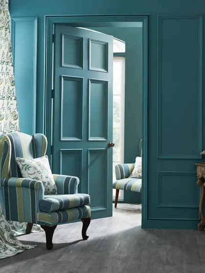 A shot for a neo-classical fabric collection. The composition uses the doorway to create a sense of depth, showing how the fabrics can be used to furnish an elegant, layered space.