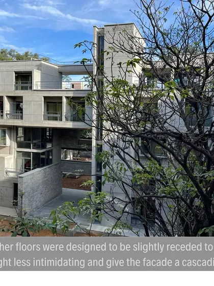 The receding upper floors of the hostel give the facade a cascading effect. This design choice helps to manage the building's scale and integrate it more gently into the campus environment.