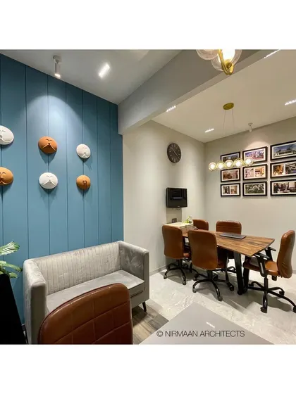 A wide shot of our conference area, featuring a blue accent wall with playful ceramic art, creating a relaxed yet focused environment for creative discussions.