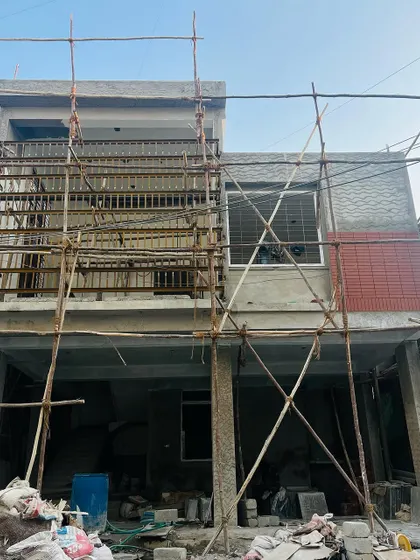 A collection of images and videos documenting various stages of construction, from site visits and foundation work to the detailed installation of architectural fittings and finishes.