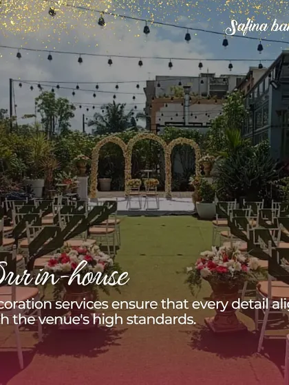A daytime view of the Sky Terrace set for a ceremony, showcasing the lush green aisle and floral archways, all handled by our in-house decoration services.