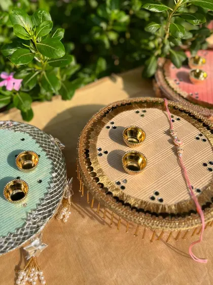 A view of two of our Rakhi thalis, showcasing the variety in color and design, from soft pastels to earthy tones.