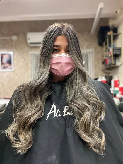 Uniqueness in every strand. This long hairstyle features a beautiful blend of ash and blonde tones, creating a unique and eye-catching balayage effect.
