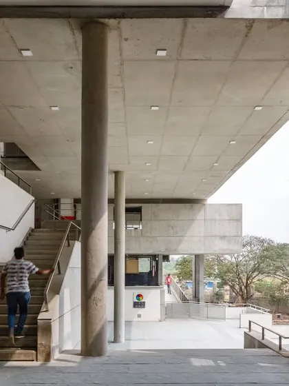 A duplicate image of a student ascending a staircase at VIT.