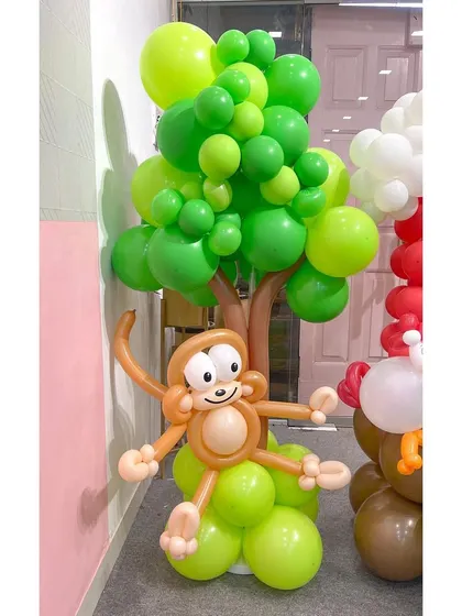 A close-up of the cheeky monkey from my farm-themed balloon sculpture. The detailed face and playful pose, hanging from a balloon tree, showcase the character and personality I put into each creation.