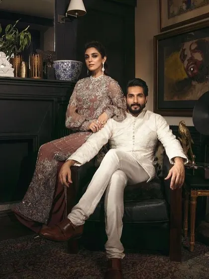 This look is about regal elegance. I designed her intricate sharara-style gown and his classic white sherwani to create a powerful, coordinated statement.