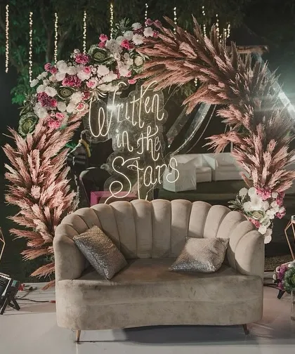 This boho-chic Sangeet seating area was a favorite. I used a plush scalloped sofa, pampas grass, and a custom neon sign to create a cozy and incredibly photogenic corner.