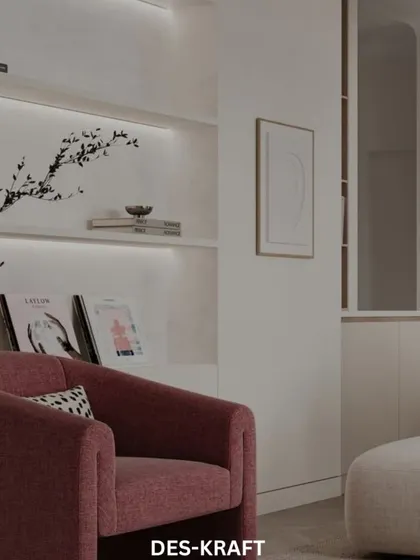 A cozy armchair in a deep rose color adds a touch of warmth and personality to this otherwise neutral and minimalist living space.
