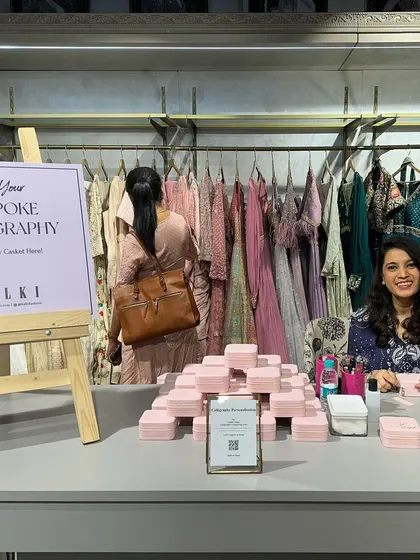 My live calligraphy station at the Kalki Fashion store. Surrounded by stunning outfits, I personalized giveaways for shoppers, adding an interactive and luxurious touch to their retail experience.