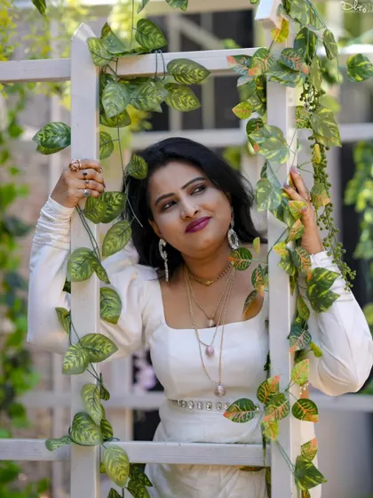 A lovely portrait framed by green vines, adding a natural and fresh element to this birthday shoot.
