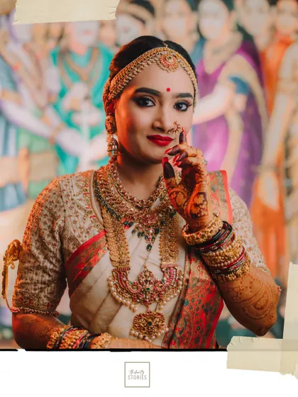 A confident and beautiful bridal portrait. The bride's direct gaze and radiant smile, combined with her traditional attire, create a powerful image.