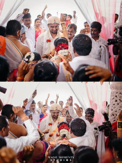 The couple's grand exit or entrance, surrounded by a crowd of cheering family and friends, creating a tunnel of celebration.
