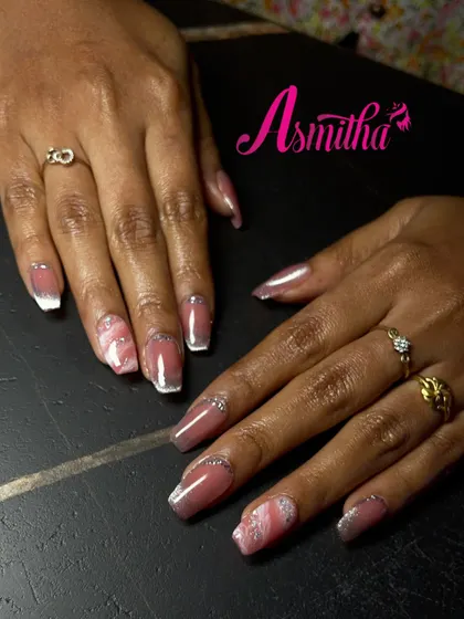 A clear, top-down view of the pink marble and glitter fade nail extensions, showing the precise application and blending of colors.