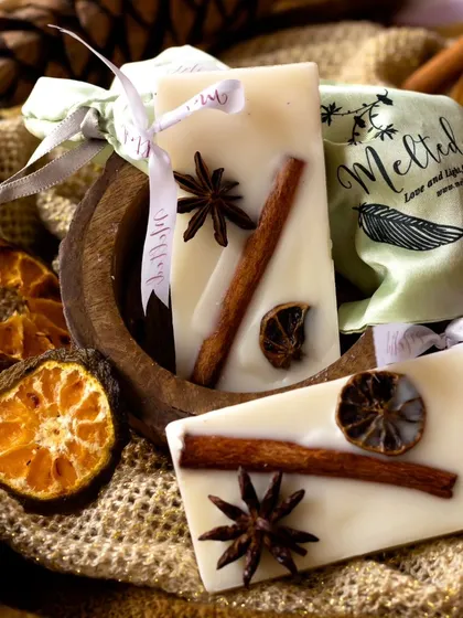 A close-up shot of the spiced wax sachets, showcasing the beautiful arrangement of natural ingredients. The earthy textures and warm tones create a cozy, autumnal atmosphere.
