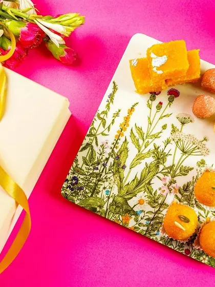 Another angle of the festive tableware flatlay, with a focus on the branding and packaging.