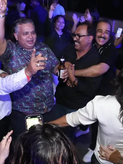 Look at those happy faces! This is what it's all about for me. A candid shot of guests completely lost in the music, hands in the air, during a private party. I live for creating this kind of pure joy.