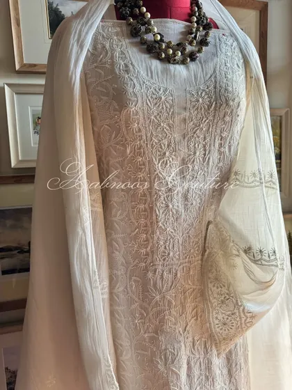 A slightly angled view of the off-white kurta, showing the texture of the hand-embroidery and the drape of the fabric.