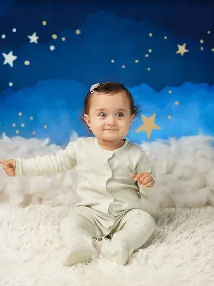 A playful moment as the baby points to something off-camera. These candid shots show off her curious and interactive nature.