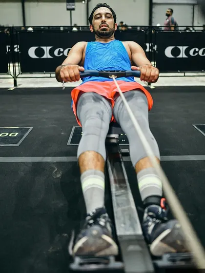 On the rower during a Hyrox competition. This machine is a full-body workout that builds both cardiovascular endurance and muscular strength.