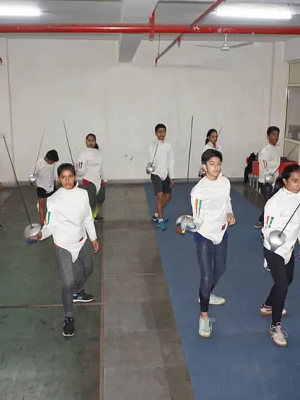 Students practicing forward and backward steps on the piste. Mastering fencing footwork is the foundation upon which all other skills are built.