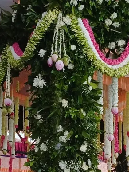 A detailed shot of the floral garlands on a traditional mandap, showing the beautiful combination of colors and textures.
