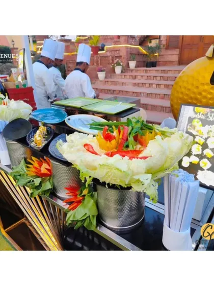The setup of our live sushi and dim sum station, decorated with carved vegetables, ready for service at an outdoor event.