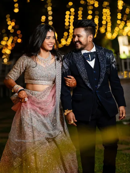 A classic portrait of the couple at their reception, looking elegant and happy. The soft lighting and their joyful expressions make this a timeless photo.