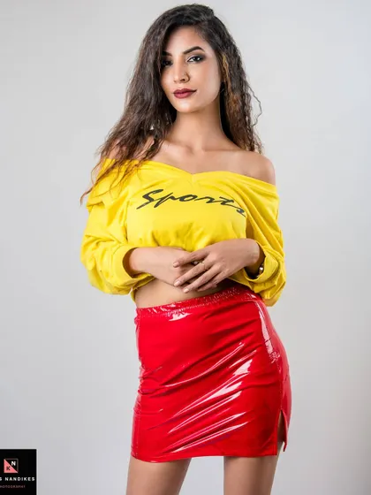 A full-frontal pose from the "I'm Lovin' It" series. The model's confident stance in her yellow top and red vinyl skirt captures a bold and modern fashion statement.