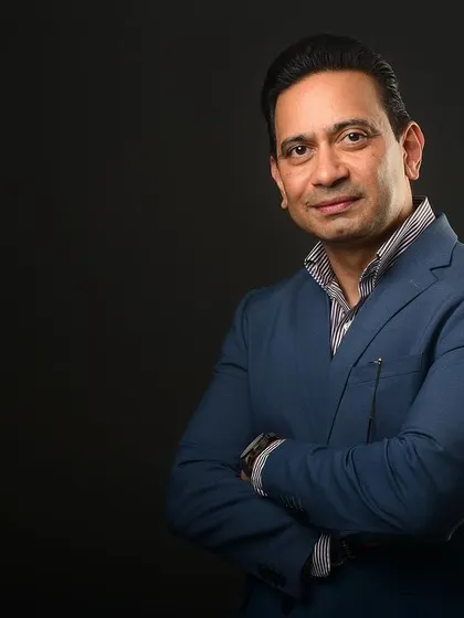 A confident portrait with arms crossed. This is a go-to pose for conveying leadership and self-assurance in a professional headshot.