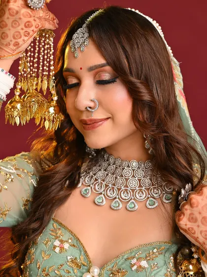 A beautiful close-up of a student's portfolio work. This soft, shimmery eye makeup paired with a diamond nose ring and jewelry is a perfect example of a modern engagement or reception look.