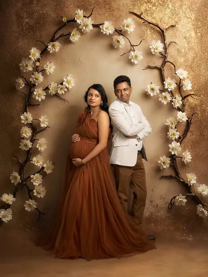 A stylish couple's portrait in our studio. The Copper gown and the partner's coordinated outfit create a cohesive and fashionable look.