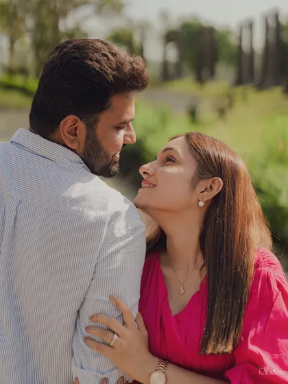 A lovely close-up focusing on the adoring gaze between the couple, with the soft, natural background of the park.